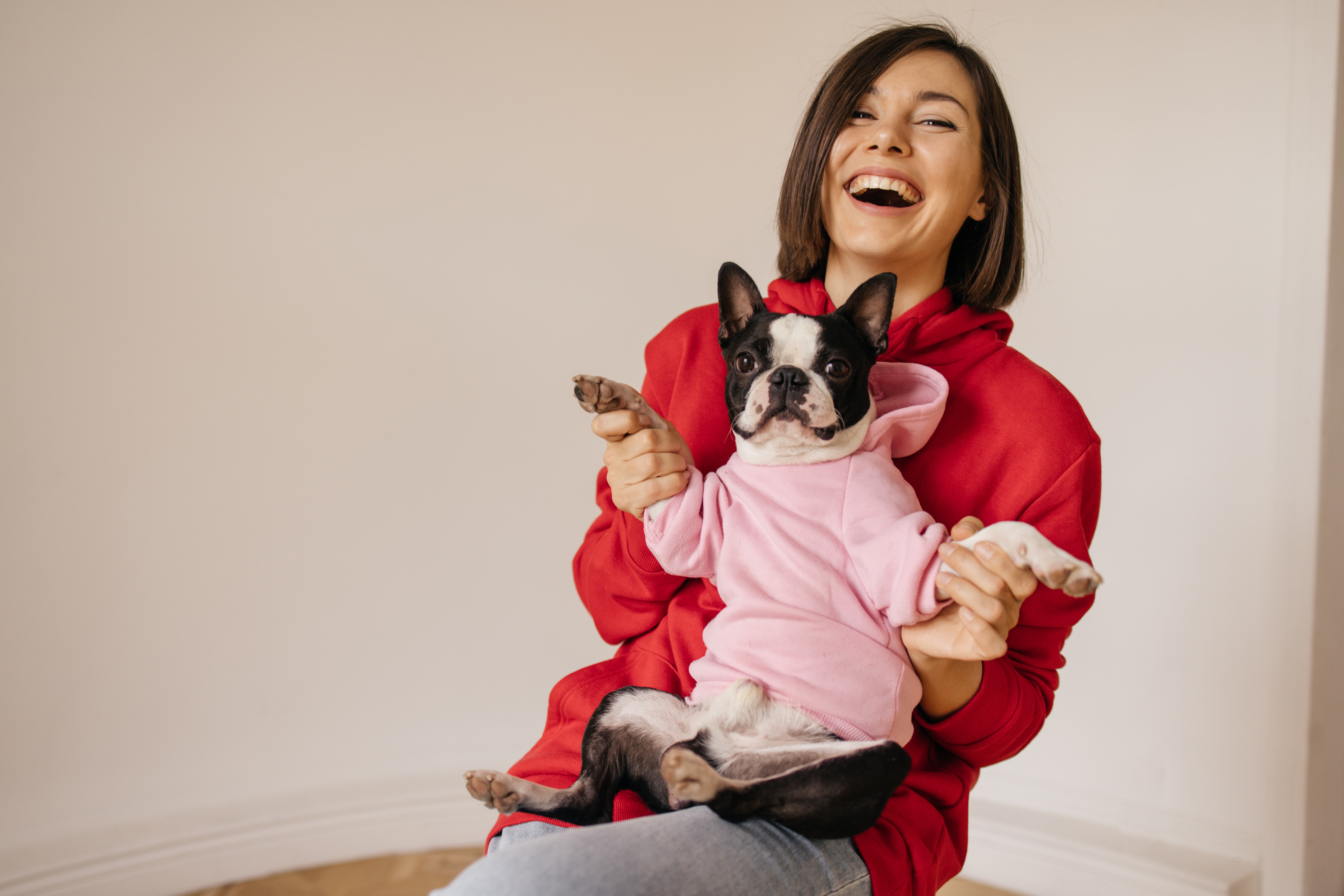 beautiful-caucasian-young-girl-laughs-while-holding-boston-terrier-dog-her-knees-white-background-lifestyle-friendship-concept.jpg